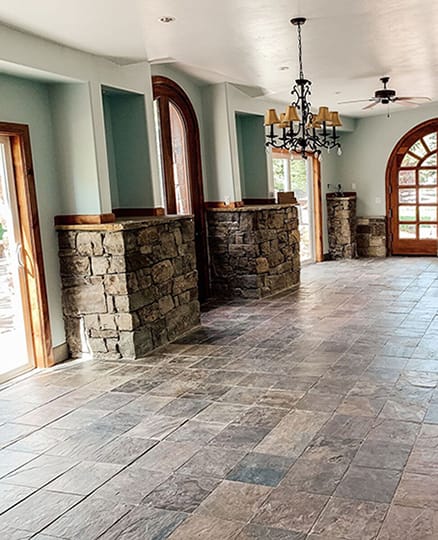 Empty dining room with outdated patio doors.