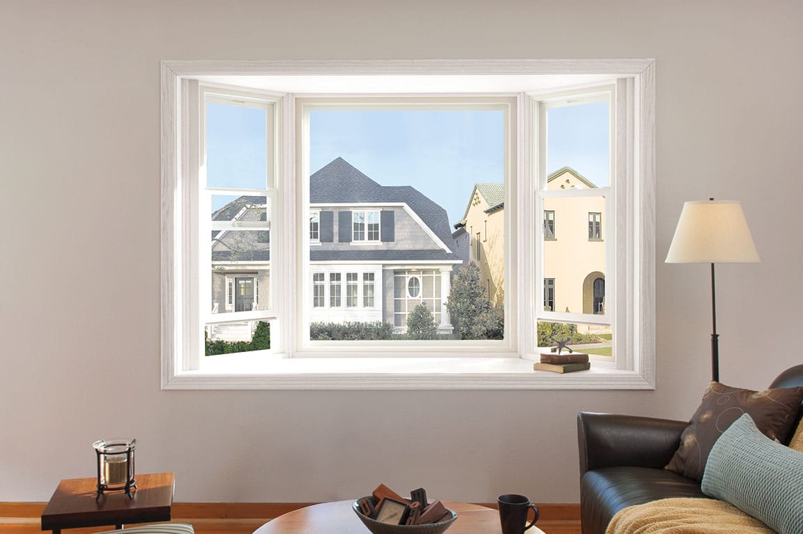 White bay windows in a contemporary living room with a view of neighbors' homes