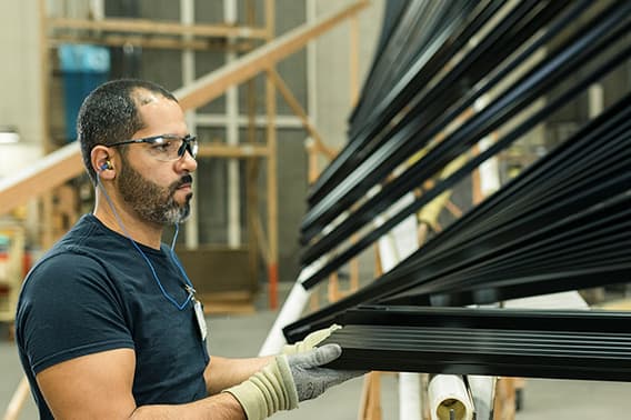 Pella worker assembling black shades