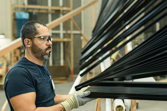 Pella worker assembling black shades