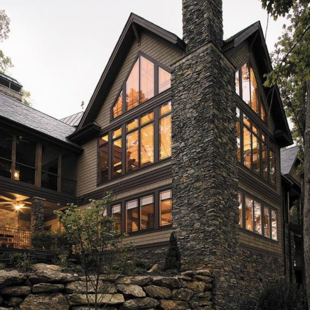 Custom Shape Windows Crafted To Follow Cabin Roofline Rustic cabin with tall walls of windows shaped with triangle shaped windows to match roofline