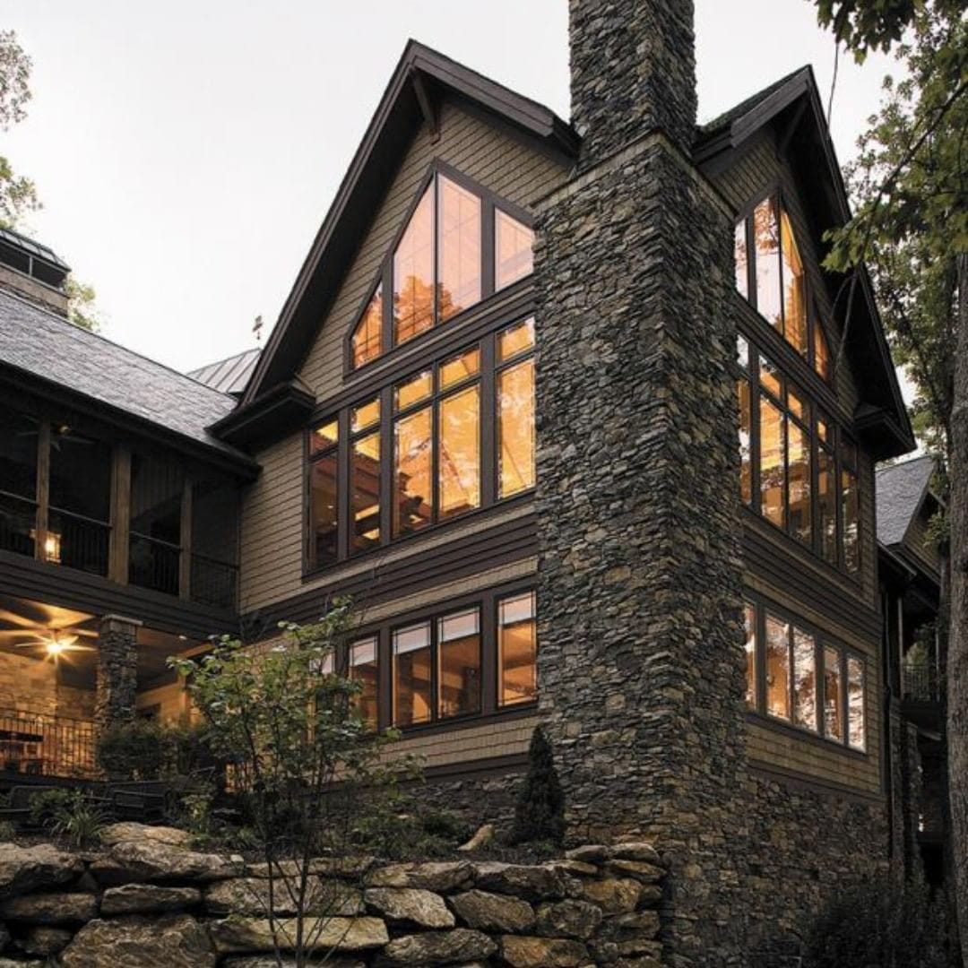 Custom Shape Windows Crafted To Follow Cabin Roofline Rustic cabin with tall walls of windows shaped with triangle shaped windows to match roofline