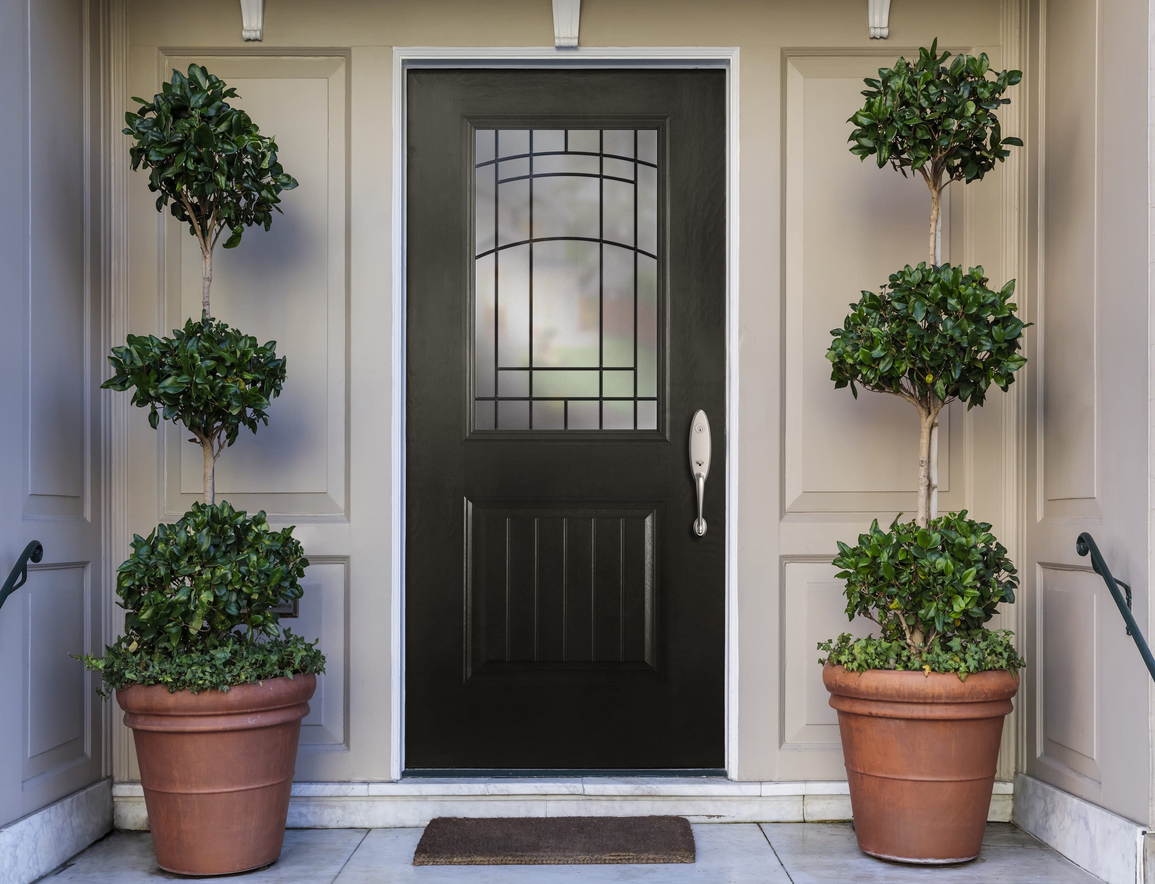 Classic Black Front Door With Decorative Glass Black front door with decorative glass and greenery on either side