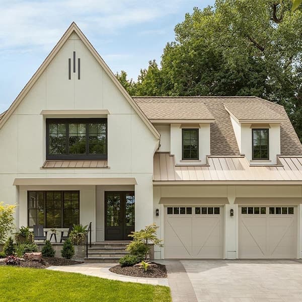 a beige-colored home with two shed dormer windows