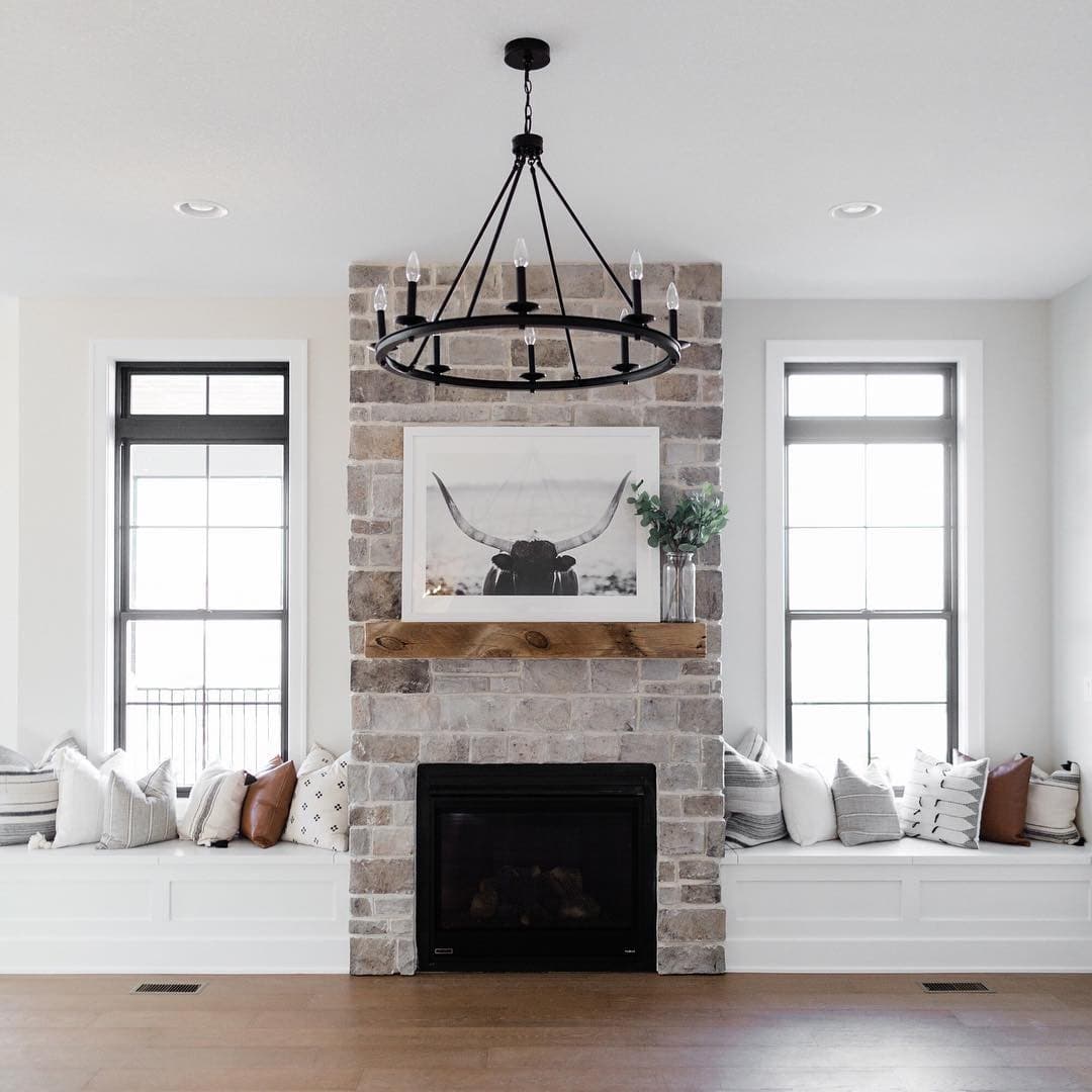 Tall Double-Hung Windows Complement Farmhouse Living Room farmhouse style living room with fireplace and black windows