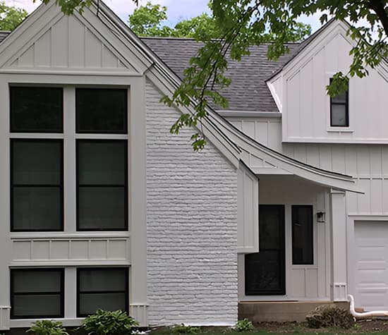 a renovated chicago farmhouse with white-washed bricks and black Pella windows