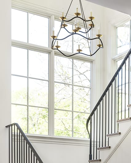 Staircase windows featuring white traditional grilles.