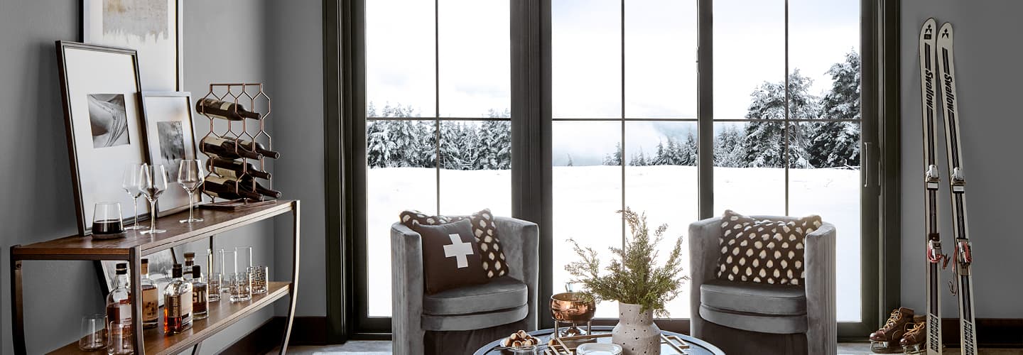 cozy living space with black sliding doors and winter scene