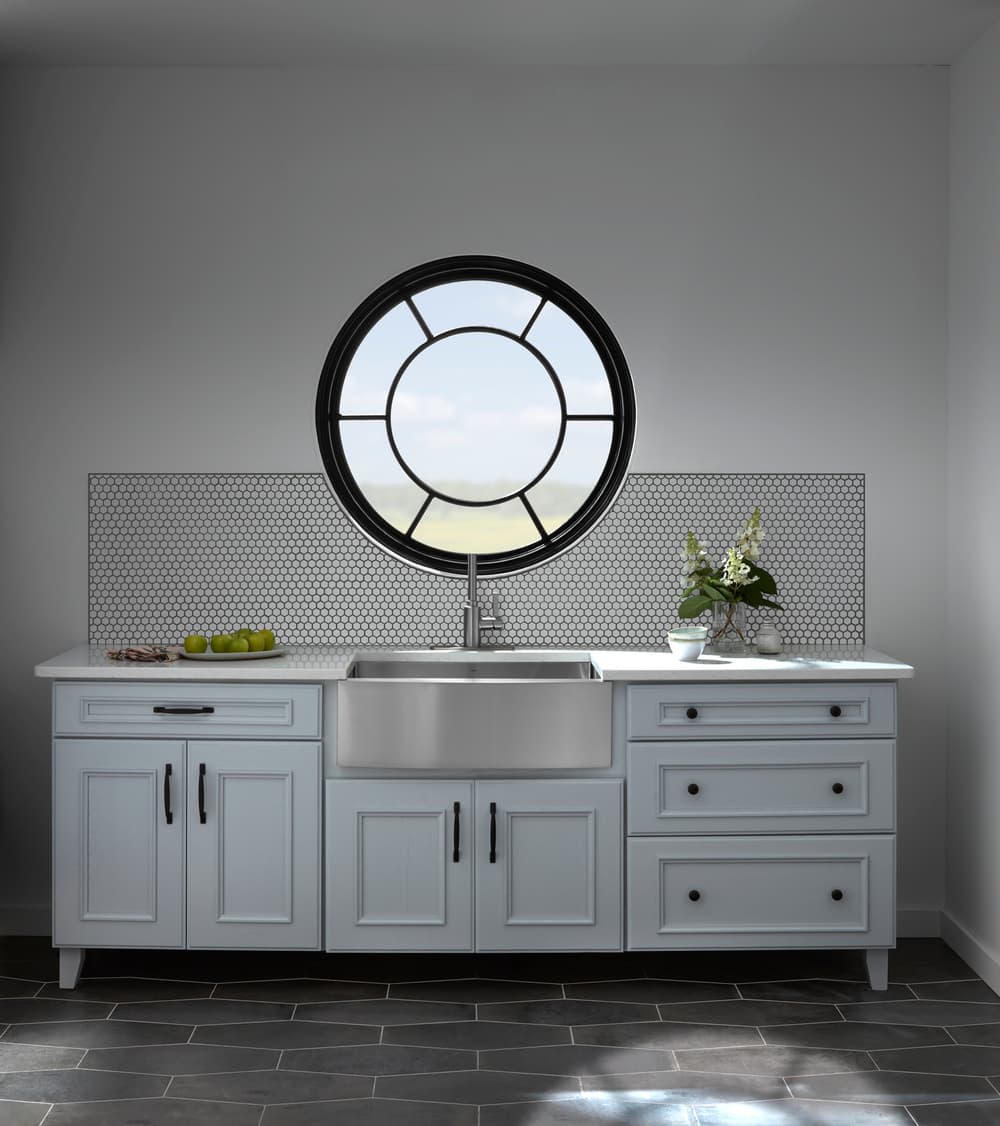 Black Circle Window With Custom Grilles Enhances Kitchen white kitchen counter and sink with black circle window with custom sunburst grilles overhead