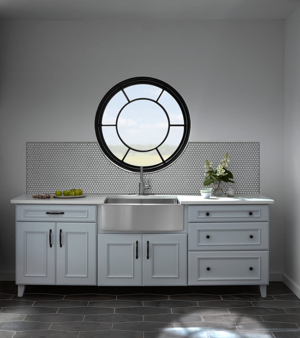 Black Circle Window With Custom Grilles Enhances Kitchen white kitchen counter and sink with black circle window with custom sunburst grilles overhead