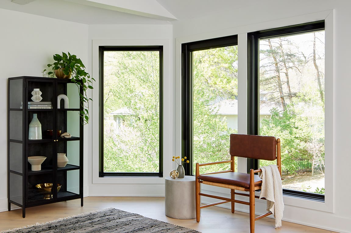 Mid-century modern room with three, large black windows.