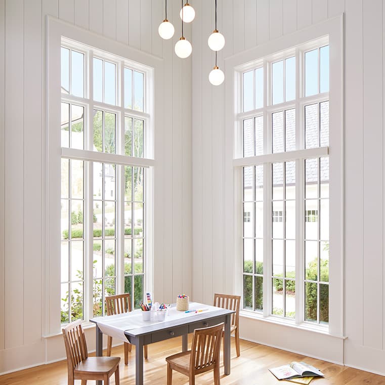 A bright dining room featuring large windows, showcasing natural light.