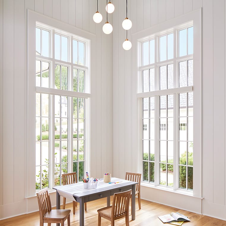 A bright dining room featuring large windows, showcasing natural light.