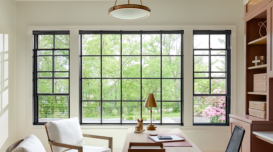 Double-Hung and fixed black windows in office of home.