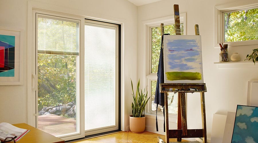 top part of a four panel sliding door with blinds between the glass