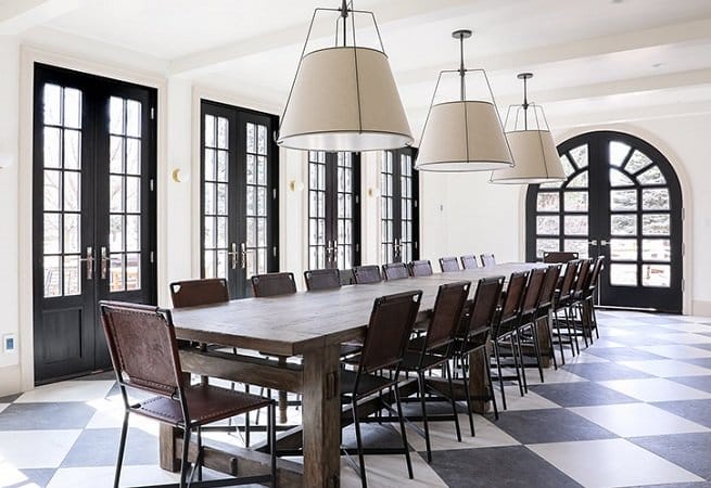 Black French Doors Line Spacious Dining Room Black french doors line the wall of contemporary dining room