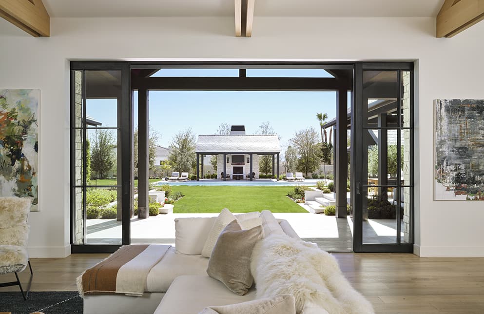 social black bifold doors open from interior to exterior patio