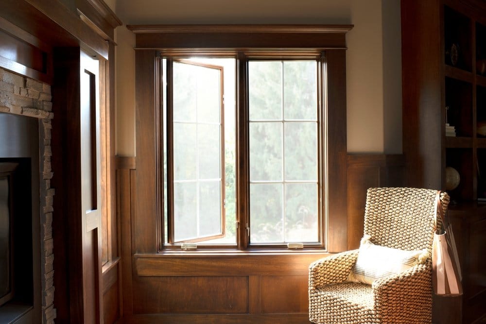 Wood Stain Windows For Cozy Home Office Wood paneled home office with two wide stained casement windows one opened and one closed