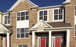 whitney apartment building with a brick exterior and red doors