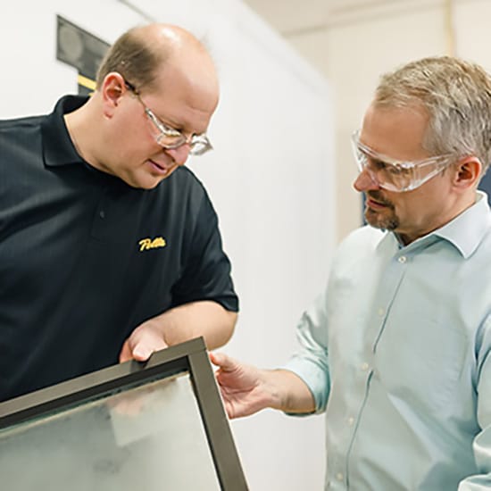two engineers working on a new window