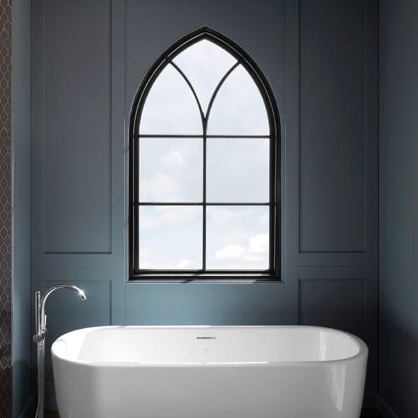 gothic window grilles over a white bathtub