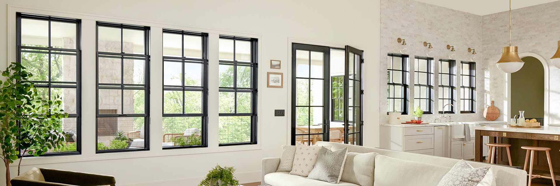 Modern traditional living room with hidden screens in black double-hung windows.