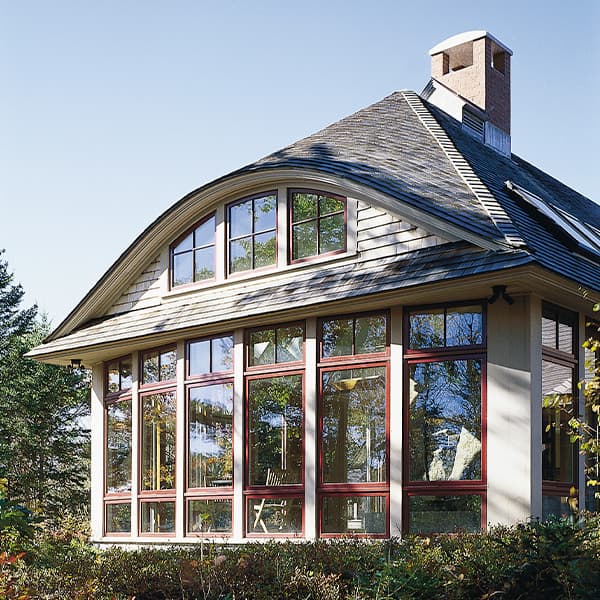 floor-to-ceiling bow window configuration and an eyebrow dormer overhead