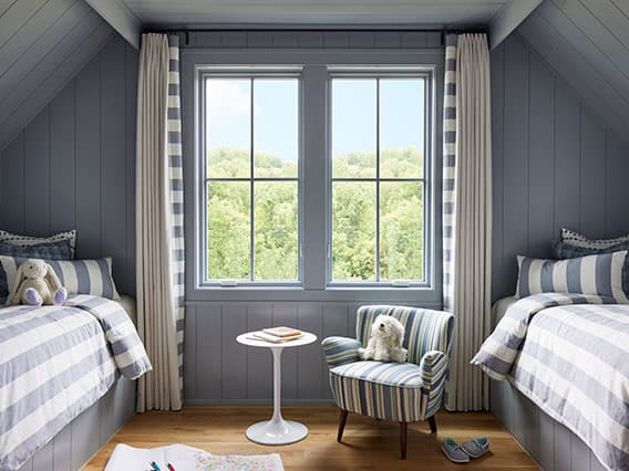 two casement windows between two child's beds