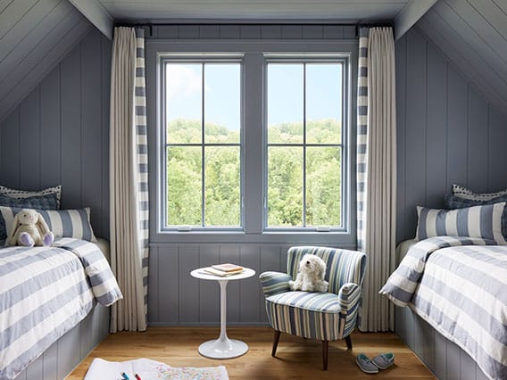 two casement windows between two child's beds