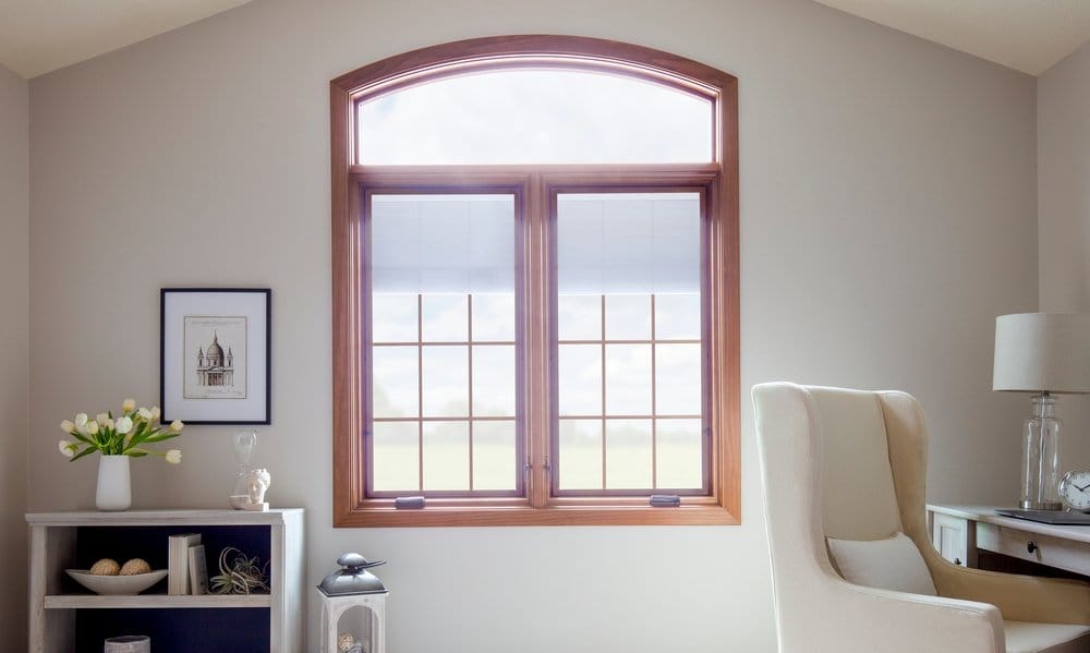 Triple-Pane Glass Window Adds Warmth To Home Office white home office with two wood casement windows with transom overhead