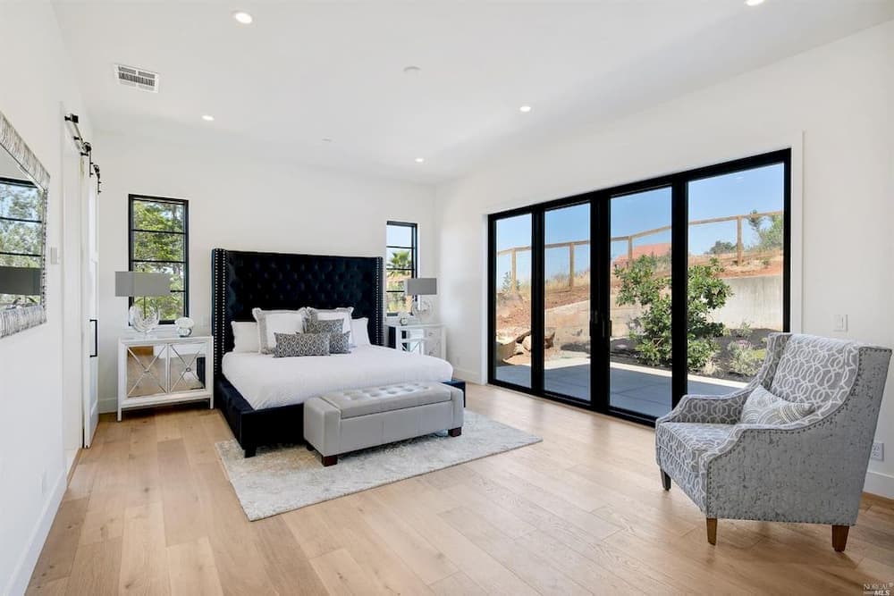 Dramatic Black, French Sliding Patio Doors For Cozy Bedroom Black sliding french doors set in bright white bedroom