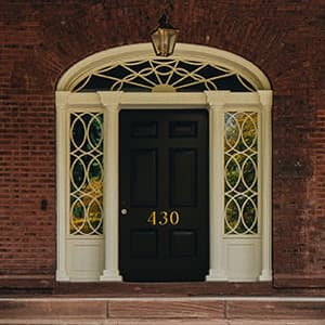 black entry door with custom grilles on transoms and sidelights