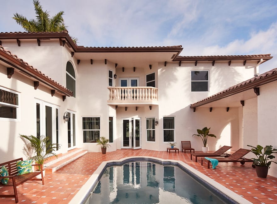 a beautiful interior courtyard with tile and a long swimming pool