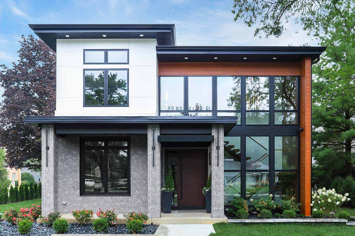 Contemporary home front elevation featuring large black windows, wood accents, and clean lines.