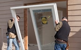 two men installing a sliding patio door