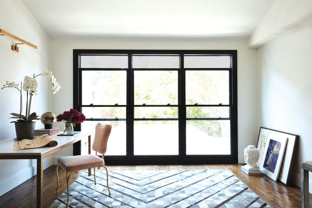Black Double-Hung Windows Add Drama To Contemporary Office Home office lit by a wall of black double-hung windows with built-in screens