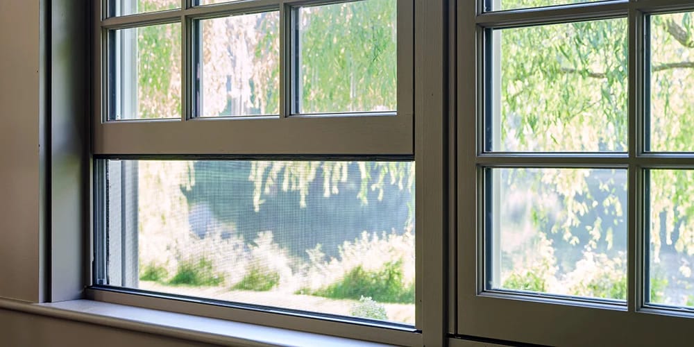 traditional living room three windows with hidden screens on the left and right windows