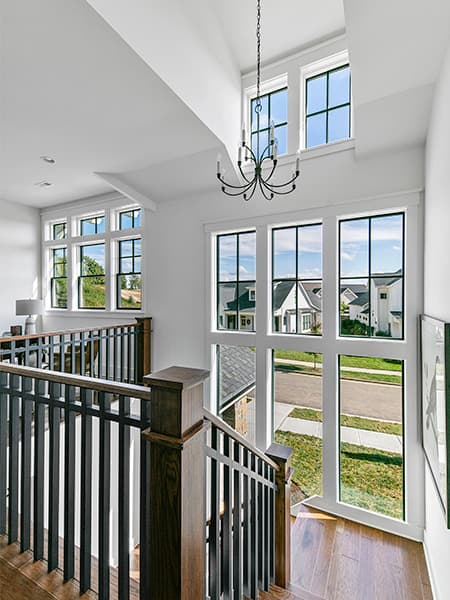 a vaulted home staircase that includes a set of dormer windows