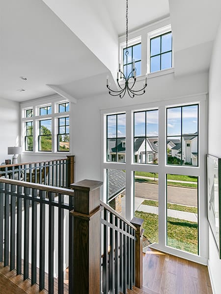 a vaulted home staircase that includes a set of dormer windows