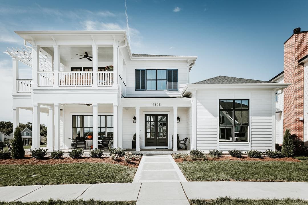 Black Windows & Doors Create Contemporary Contrast Two story white contemporary home has black windows and a black double door