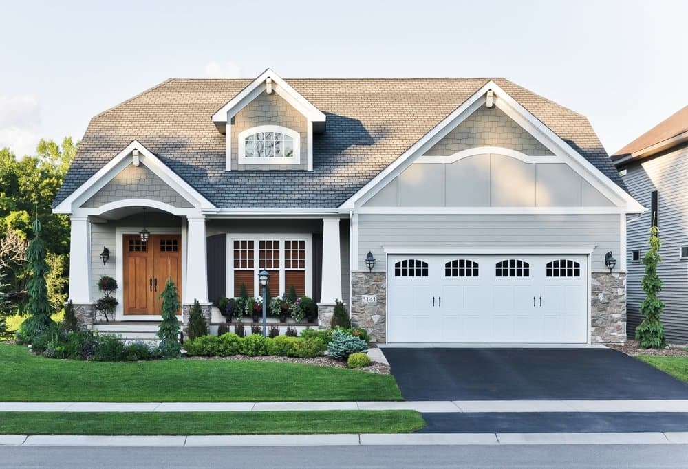 Wood Double Doors & Double-Hung Windows Enhance Craftsman Design Craftsman home with wood double doors and white double-hung windows