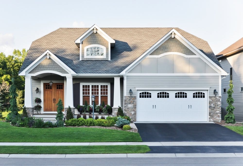 Wood Double Doors & Double-Hung Windows Enhance Craftsman Design Craftsman home with wood double doors and white double-hung windows