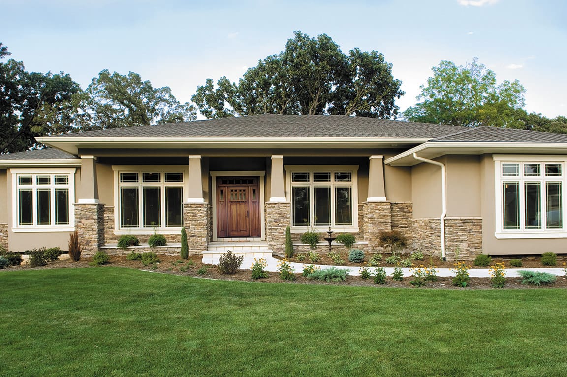 Prairie style windows on modern home with large front yard.