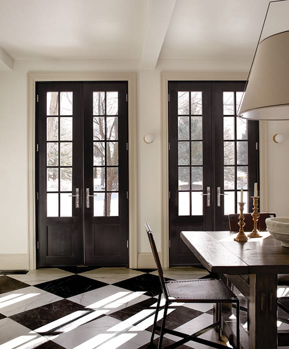 Impressive Line Up Of Black French Doors Custom black wood patio french doors in Idaho home dining hall.