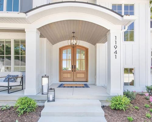 arched two-panel wood-stained front entry door 3/4 glass