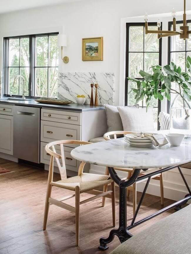 A bow window in the dining room is made up of black casement windows with simple grilles for traditional design.