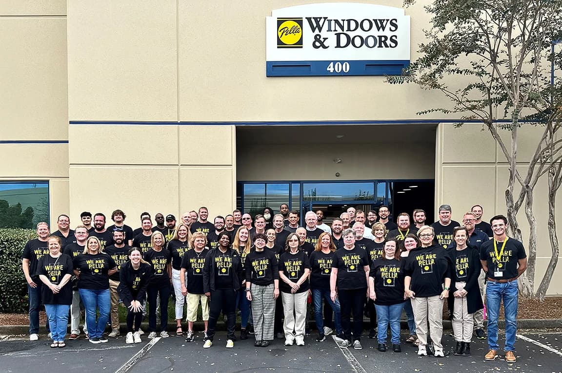 Group of people in front of a Georgia Pella Windows and Doors storefront.