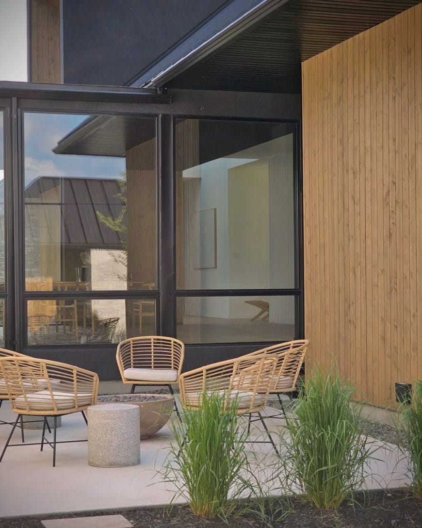 A walkout basement leads to a backyard seating area with chairs surrounding a firepit.
