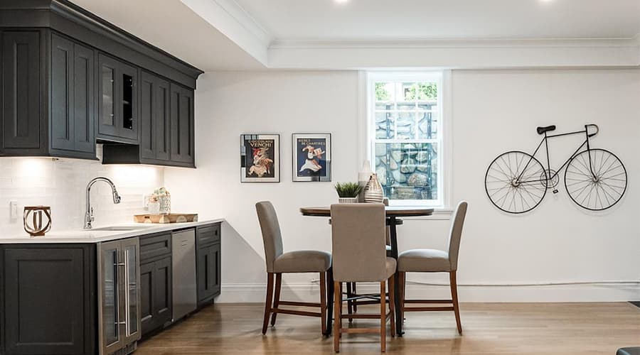 a basement kitchenette and a single white egress window