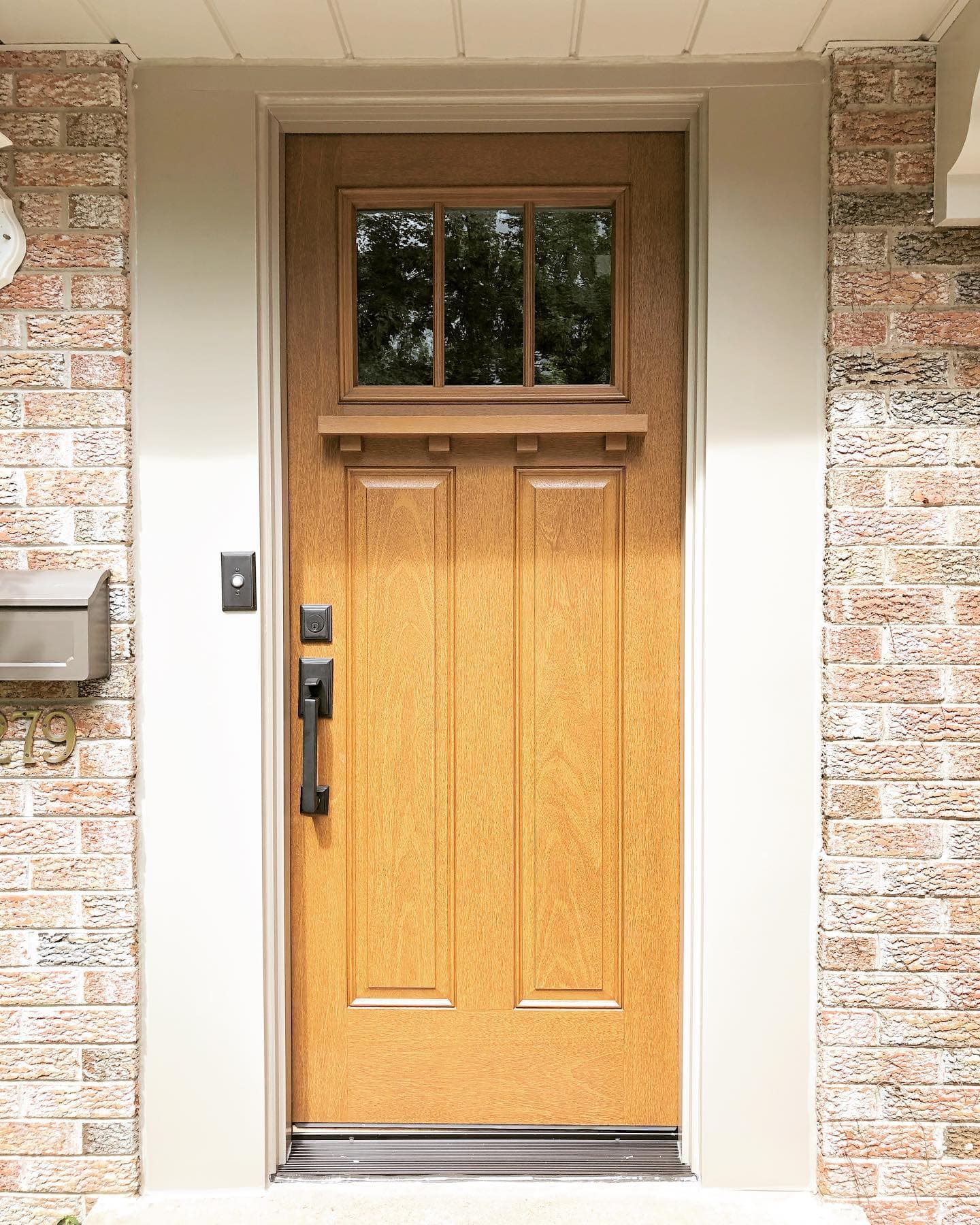 Craftsman Style Front Door Made Of Durable Fiberglass Craftsman style front door in fiberglass wood grain on brick house